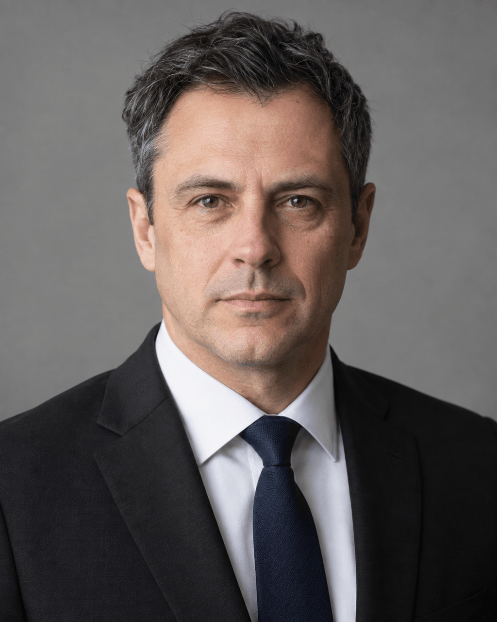 Generated example of a litigation attorney: black suit, white shirt, dark navy tie, plain gray background, serious expression